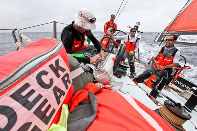 Brad Marsh getting rope out of the stacked bags on Groupama Sailing Team during leg 4 of the Volvo Ocean Race 2011-12 © Yann Riou/Groupama Sailing Team /Volvo Ocean Race http://www.cammas-groupama.com/
